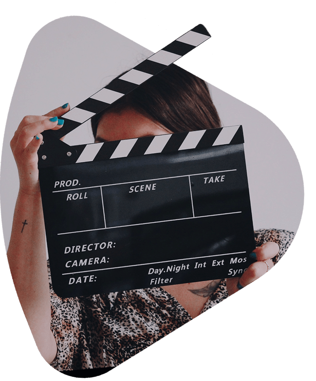 a woman holding a clapperboard from a film shoot